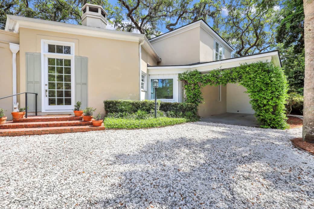 The front door is on the left and the door with the electronic keypad is  through the portico. 