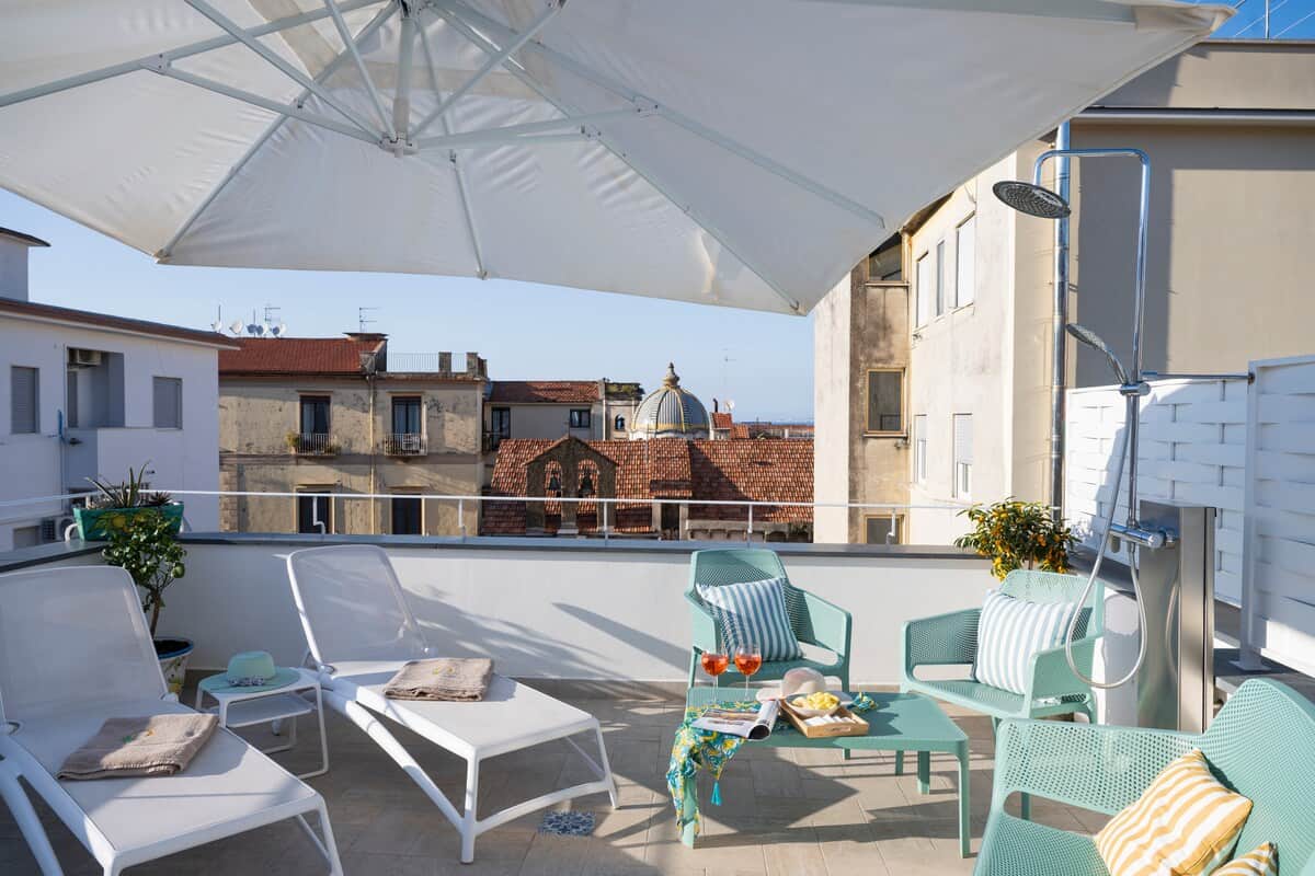 Private terrace with sun loungers, lounge area and outdoor shower in central Sorrento