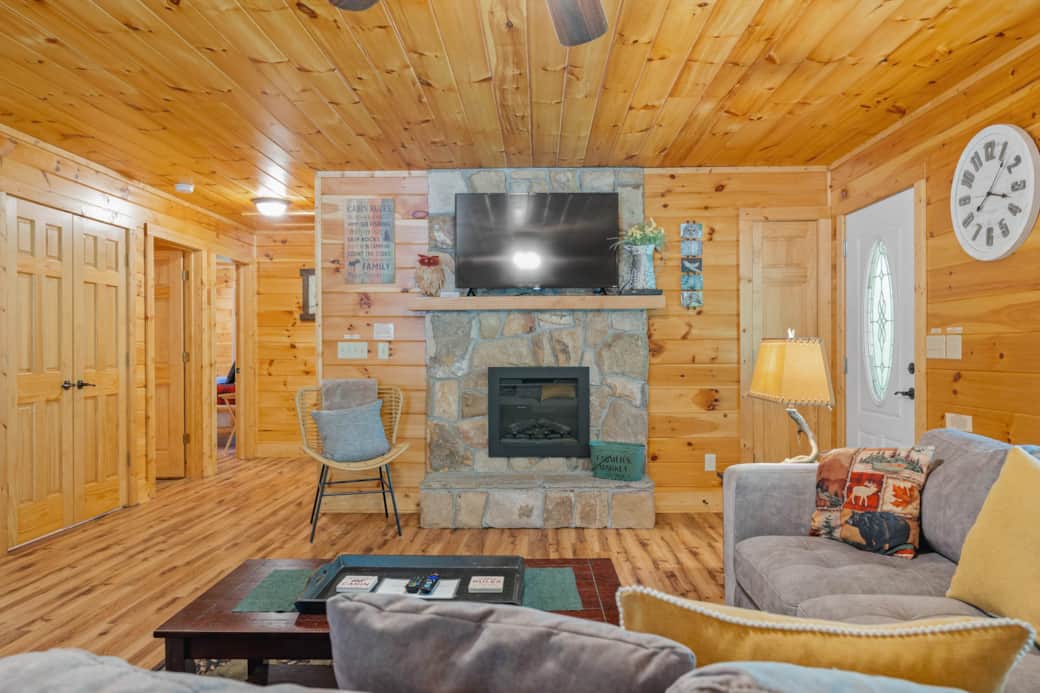 Super comfortable living room w/fireplace (door to right leads to front deck w/hot tub)