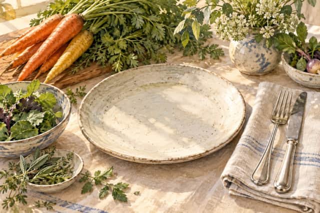 Watercolour illustration of a dinner place setting with seasonal vegetables