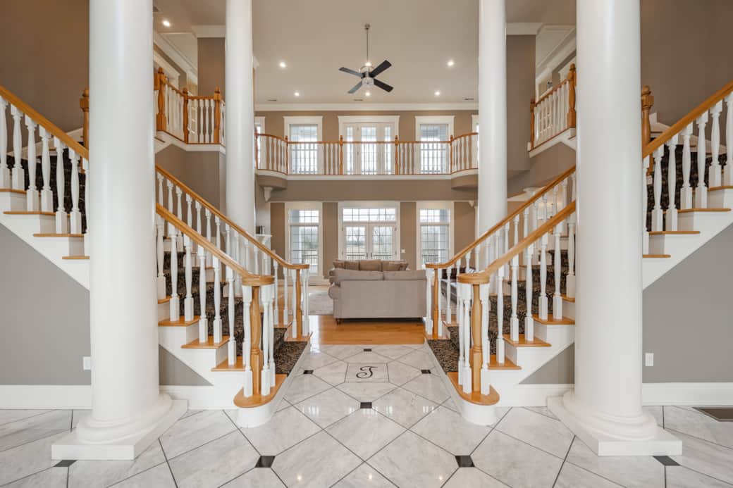 Grand double staircase with marble entryway
