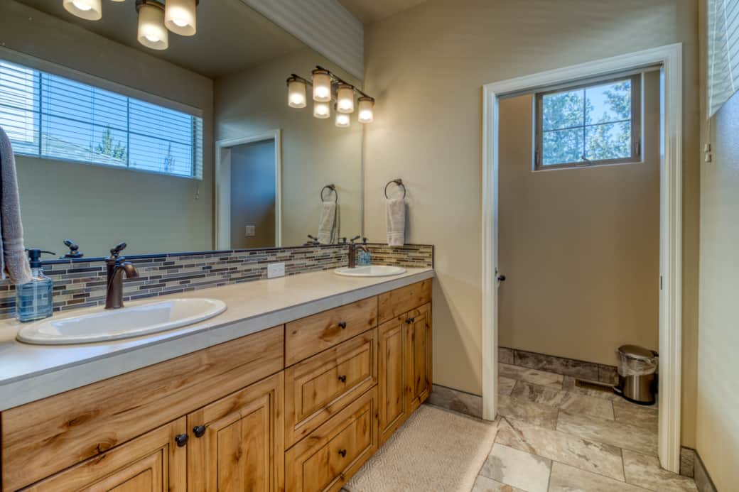 Primary suite en-suite bath with dual sinks, Alder vanity, and heated tile floors