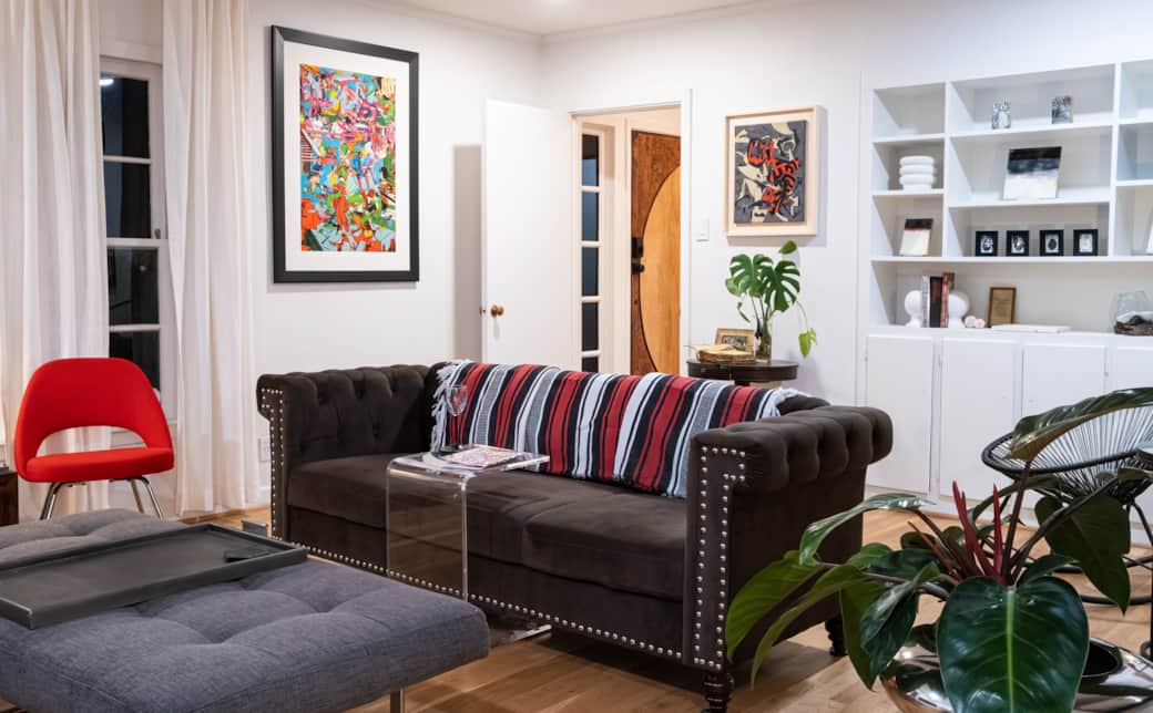 Living room sofa and a glimpse of the foyer. Custom and one-of-a-kind front door