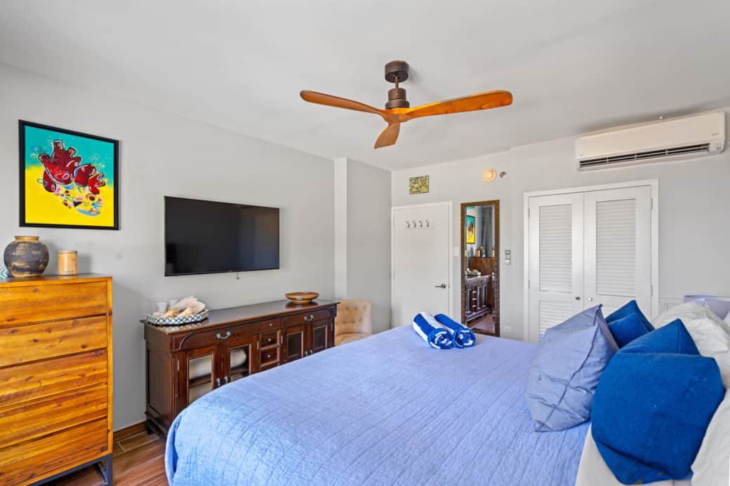 A King sized bed with a smart television