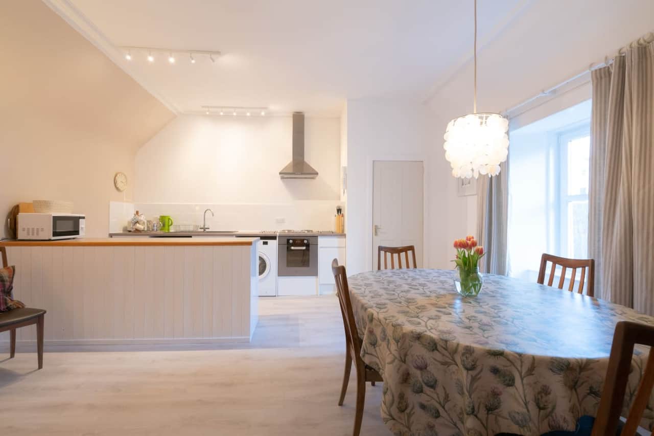 Open-plan kitchen and dining table in Aros Mains Apartment