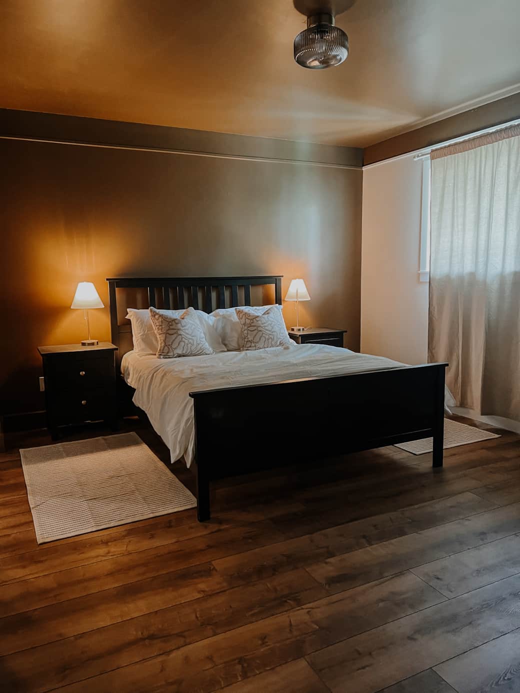 The room features a comfortable queen bed in a private room for a restful night’s sleep.