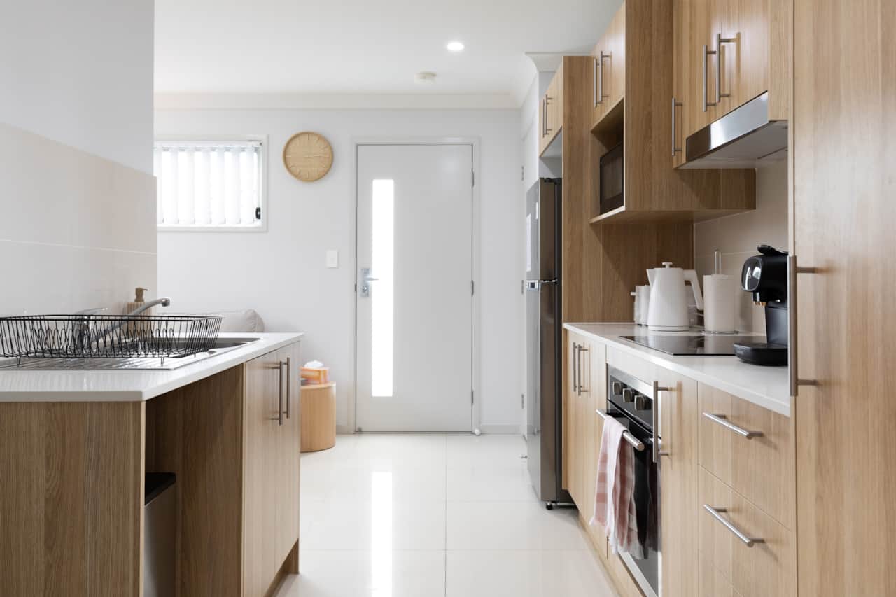 Kitchen: Sleek kitchen with ample storage, modern appliances 