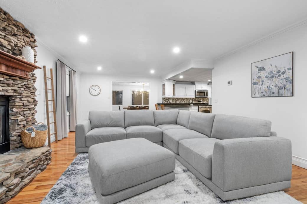 The living area flows seamlessly to the kitchen and dining areas