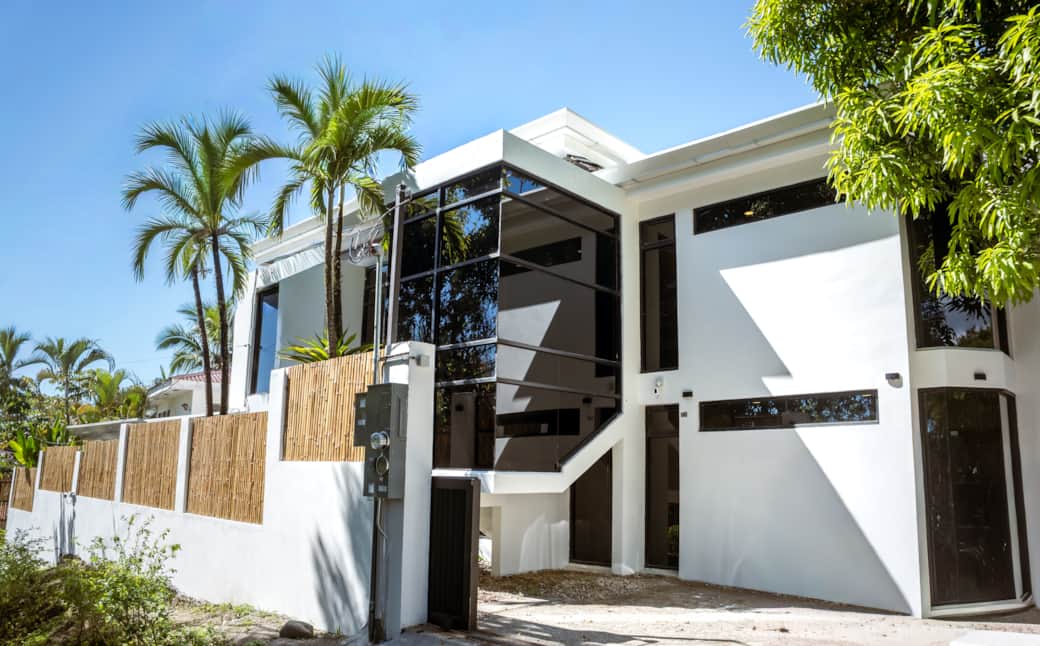 Striking modern exterior with clean lines, tropical landscaping, and private entry. Striking modern exterior with clean lines, tropical landscaping, and private entry.