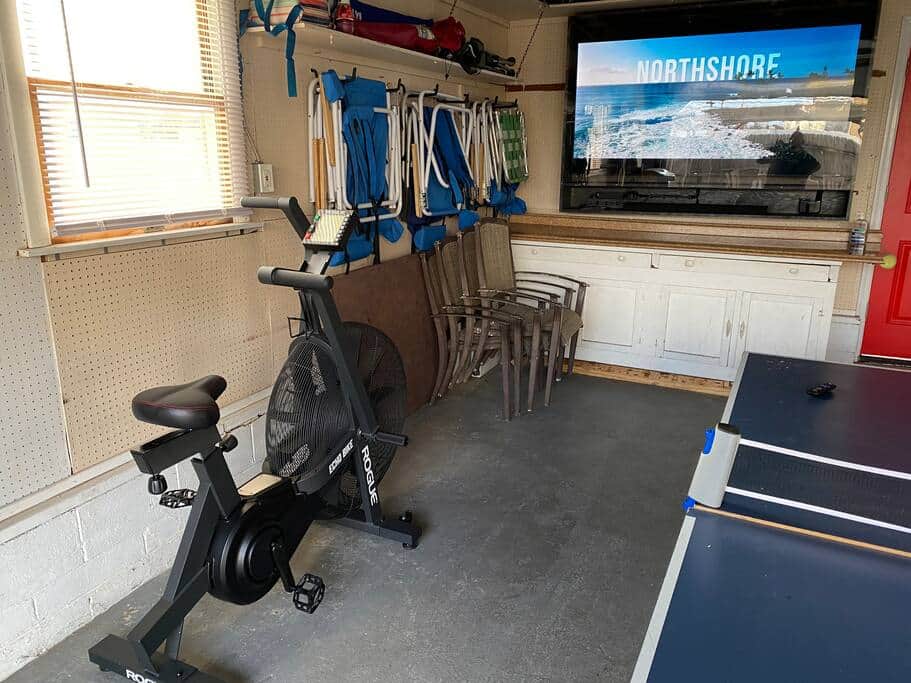 Rogue Echo Bike for cardio while watching the 75inch TV. Beach chairs, spare tables and chairs.