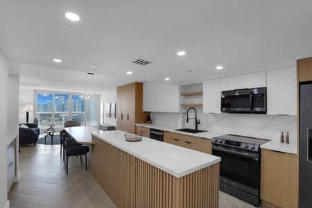 Fully equipped kitchen with seating for 6, living area with streaming tv and balcony access.