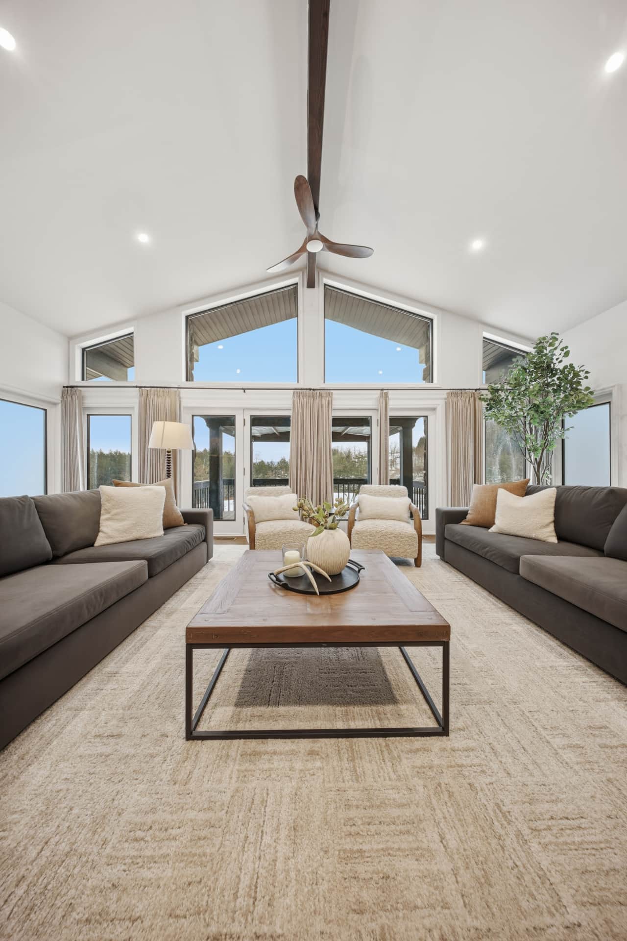 Spacious first floor living room with cozy fireplace, plush seating, and room to gather and unwind