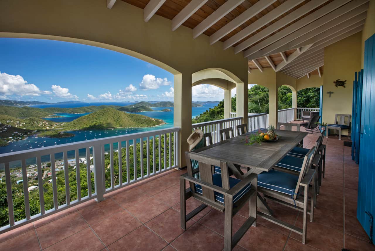 Outdoor dining table on upper level porch