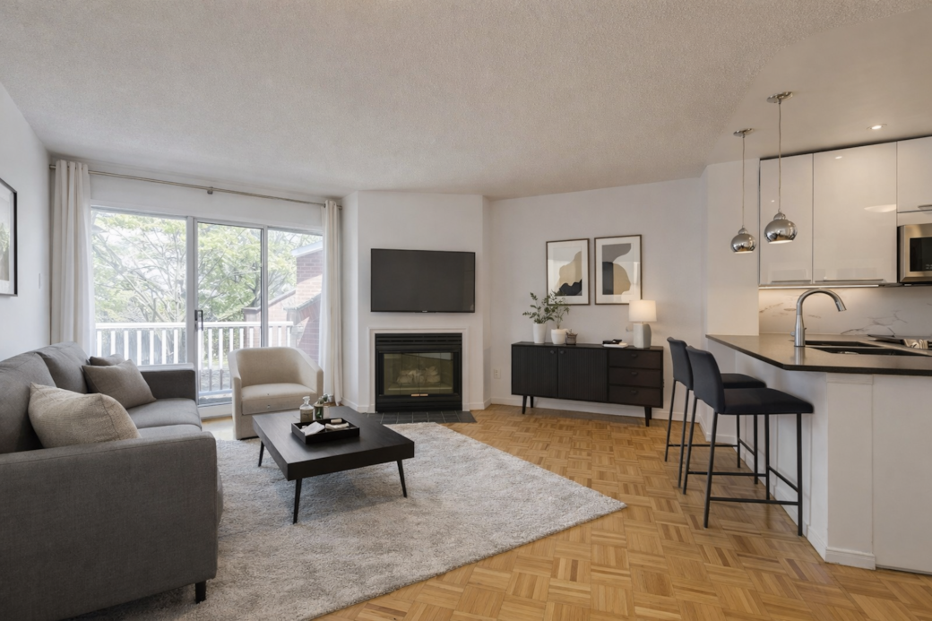 Bright living area with fireplace and balcony Bright living area with fireplace and balcony