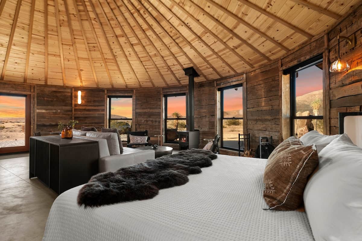 An uncompromising interior statement. 150-year-old reclaimed beams frame the vaulted cedar ceiling,