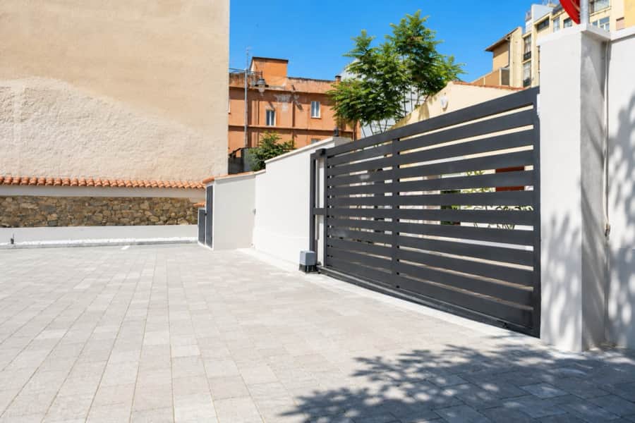 Gated entrance of the RENTAL12 private parking facility at Via Sassari 20, Olbia, Sardinia