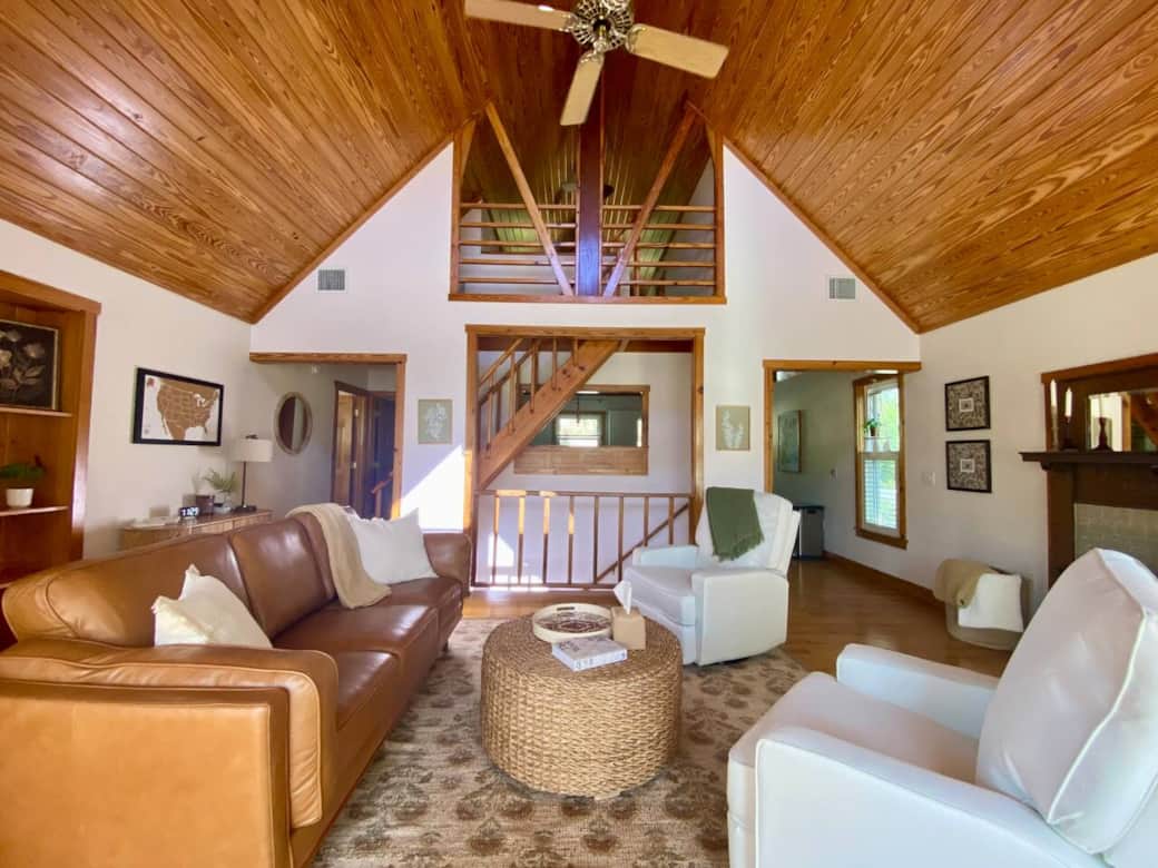 Open living room with a fireplace, leather sofa and recliner/swivel chairs. Open living room with a fireplace, leather sofa and recliner/swivel chairs.