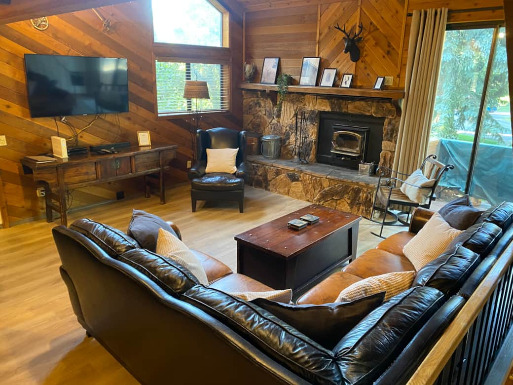 Living room with smart TV, bluetooth sound bar, and wood burning fireplace (2nd floor)