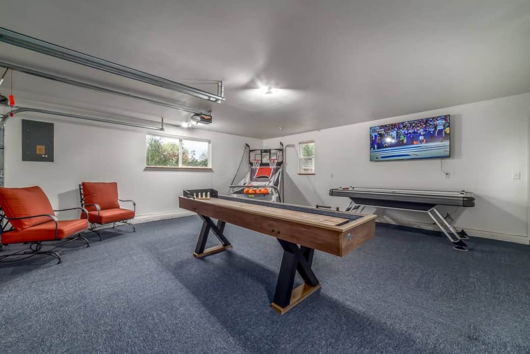Converted Game room with shuffleboard table, air hockey table and arcade basketball game. 55 inch Roku TV. Converted Game room with shuffleboard table, air hockey table and arcade basketball game. 55 inch Roku TV.