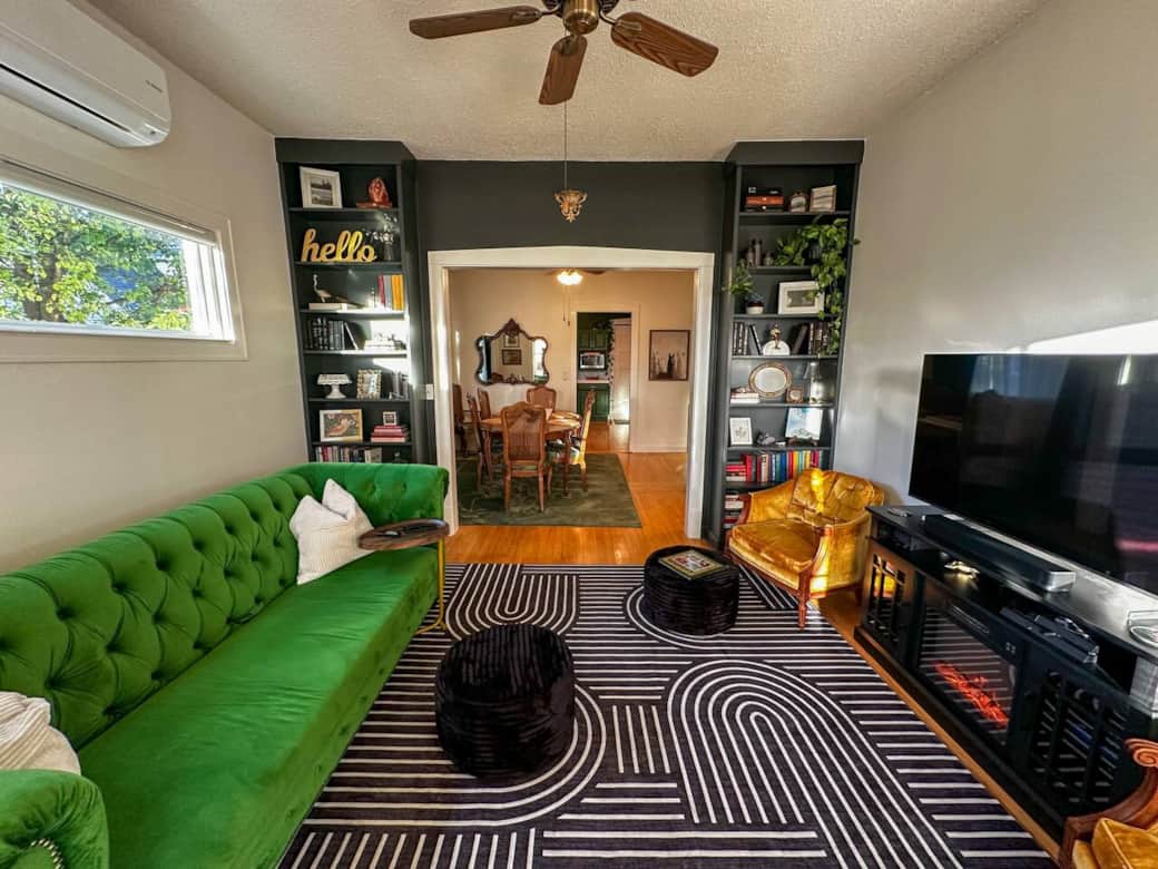 Cozy, eclectic living room with built in book shelves provides plenty of entertainment.
