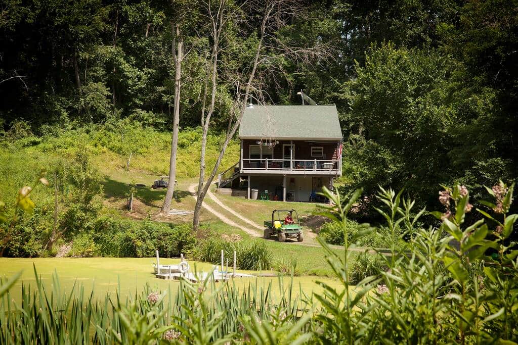 The cabin secludes itself in a bowl of trees every Spring.