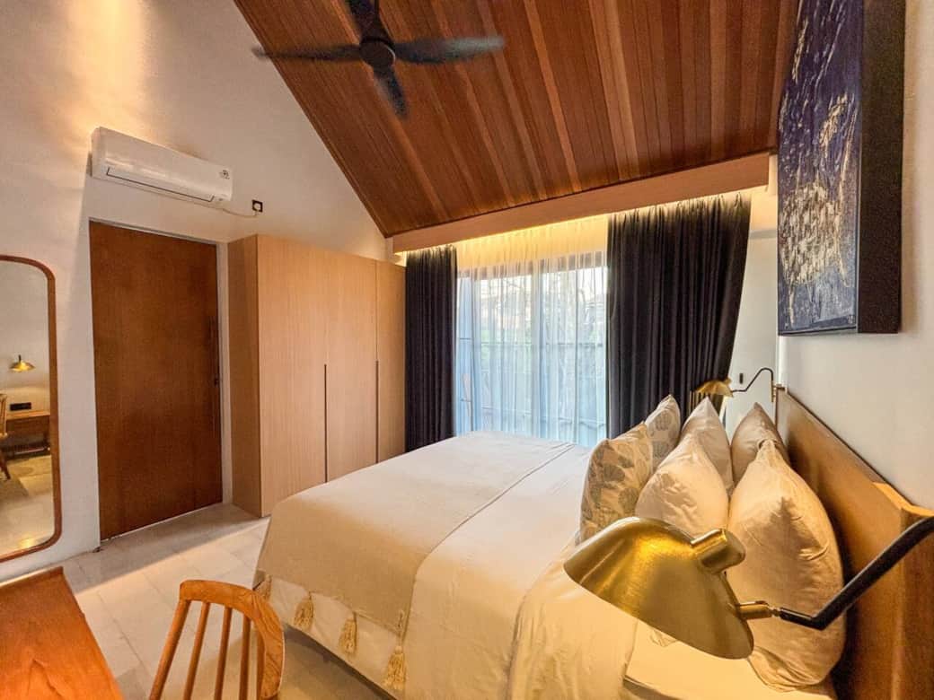 Bedroom 1 - Bedroom 1 opens to a balcony overlooking the pool, the temple, the creek, and tropical gardens.