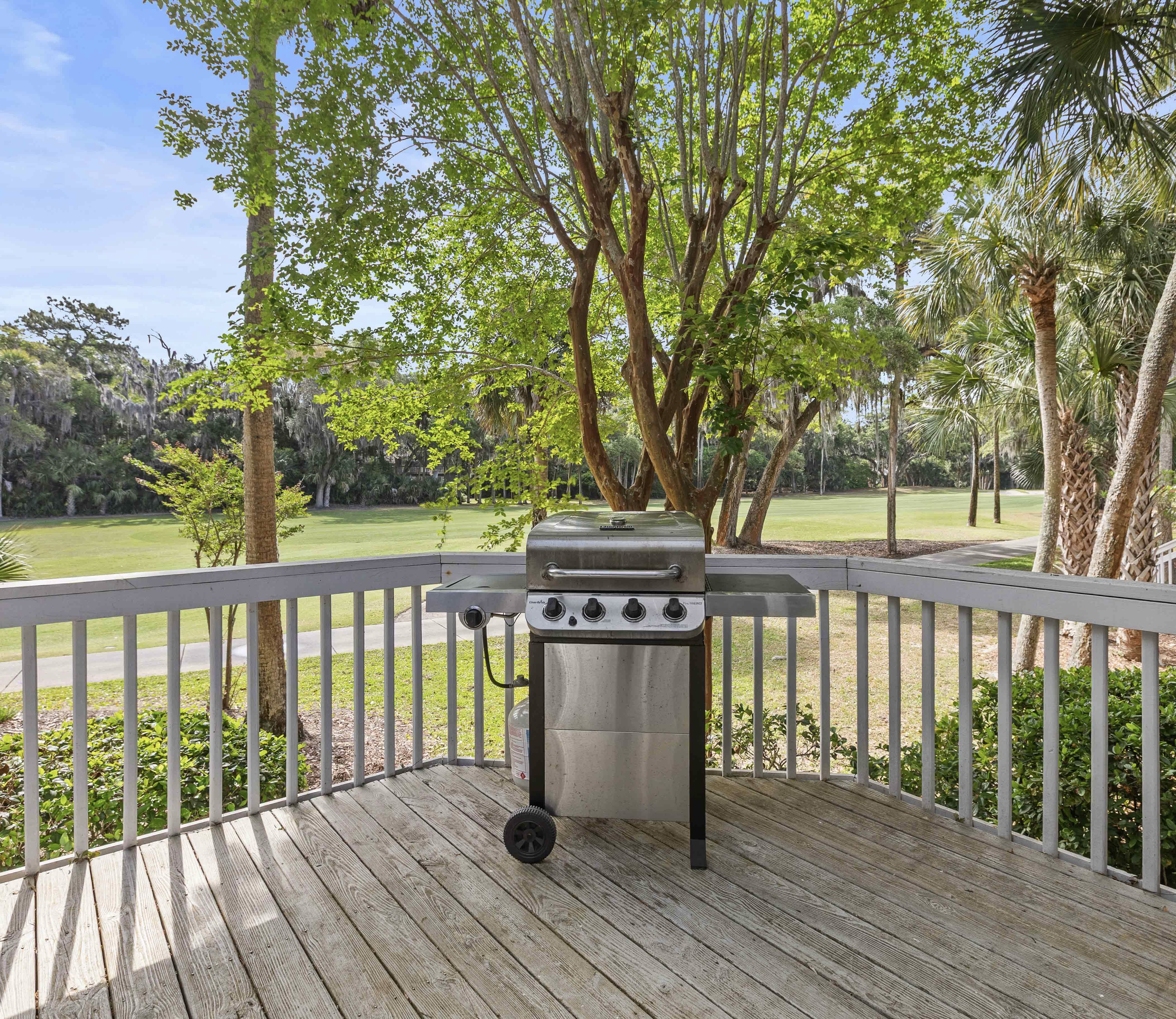 Gas grill on the deck, fairway behind