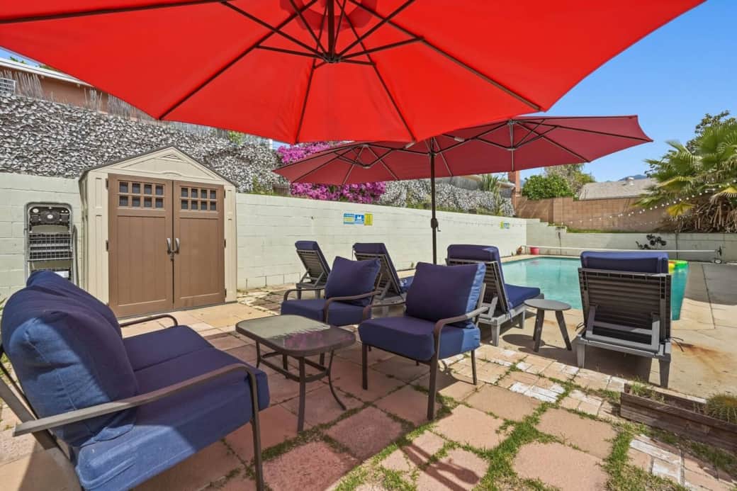 Spacious patio with lounge seating by the pool, perfect for relaxing or gathering outdoors