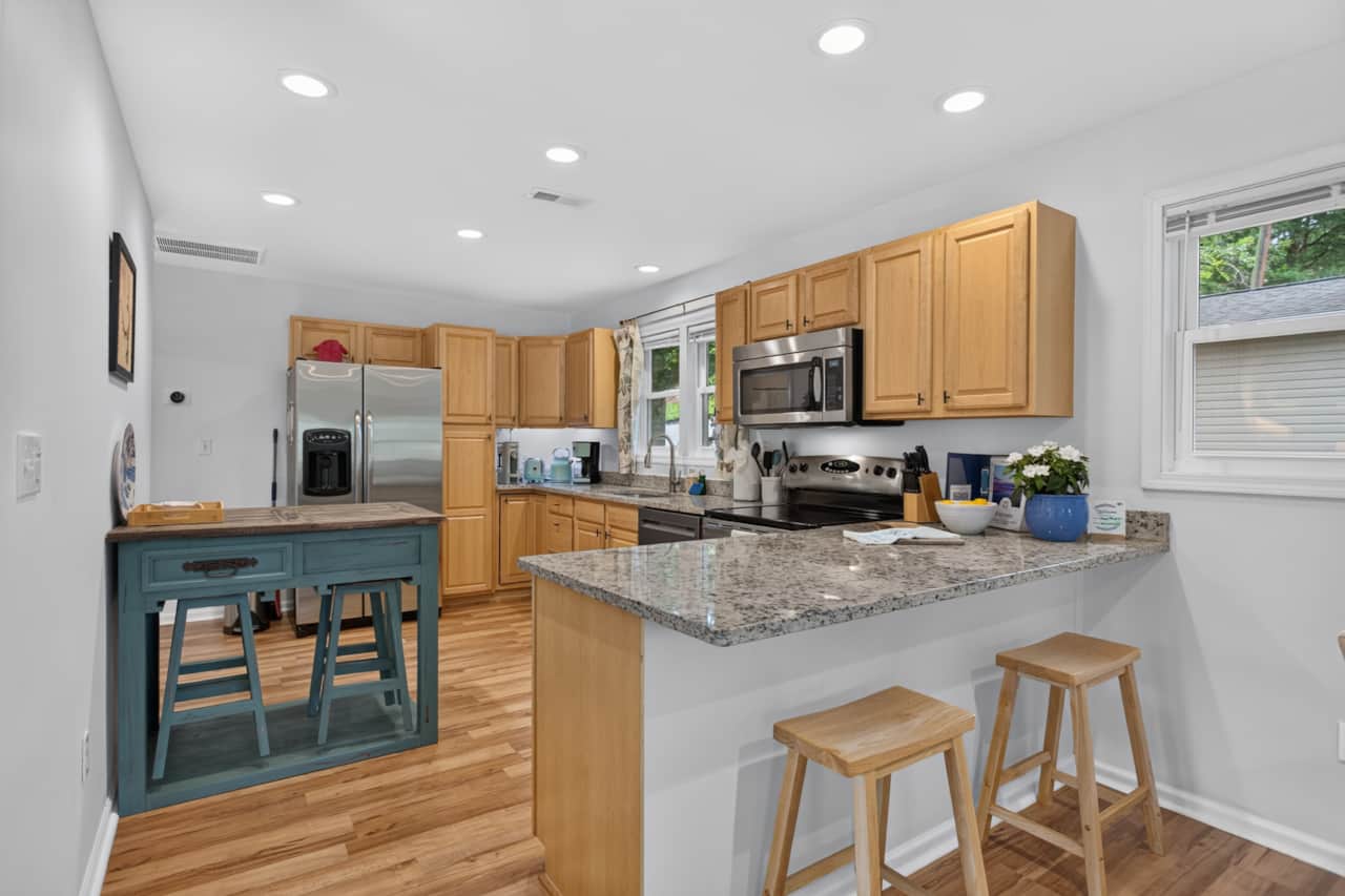 Kitchen with granite counters, eat up counter seating for 3
