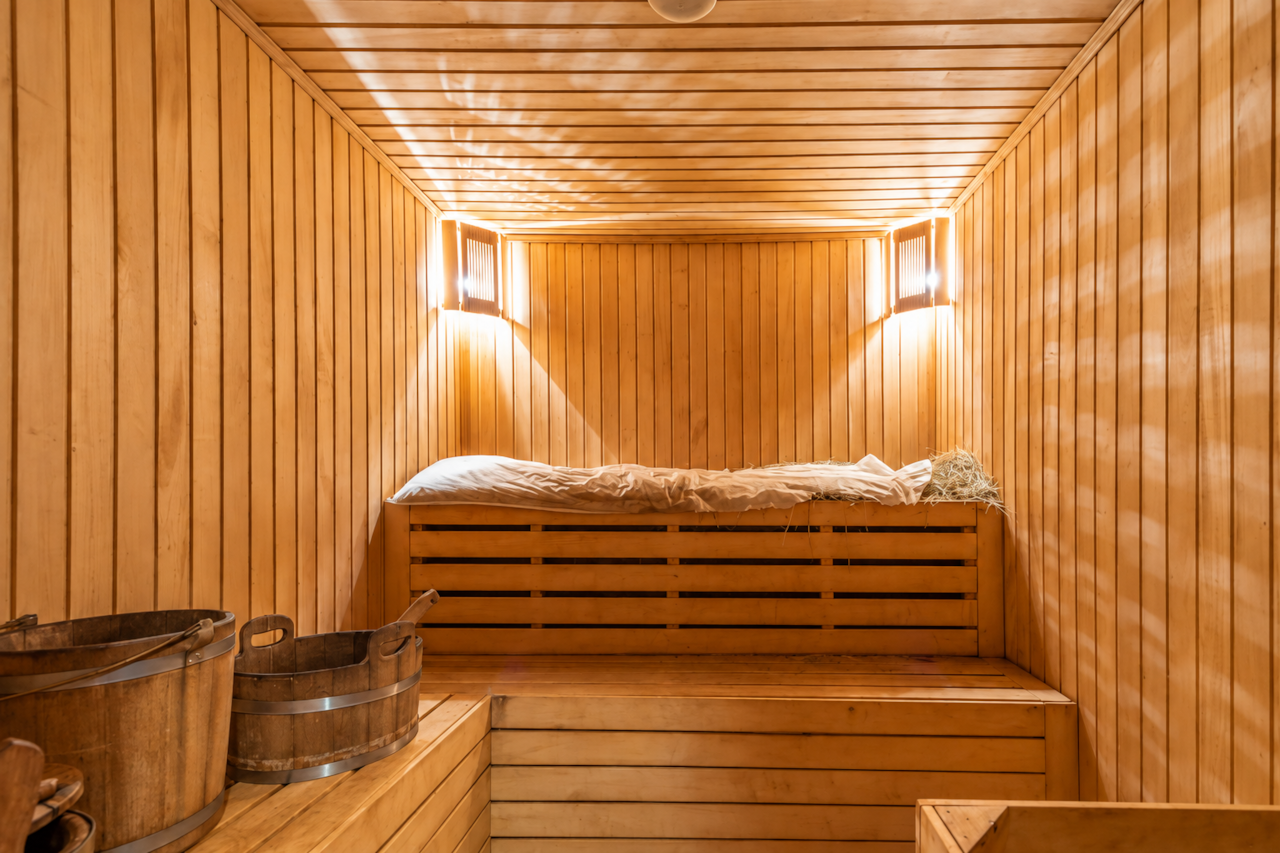Sauna finlandesa privada de madera clara vista de frente, bancos a dos alturas, wellness Corralejo
