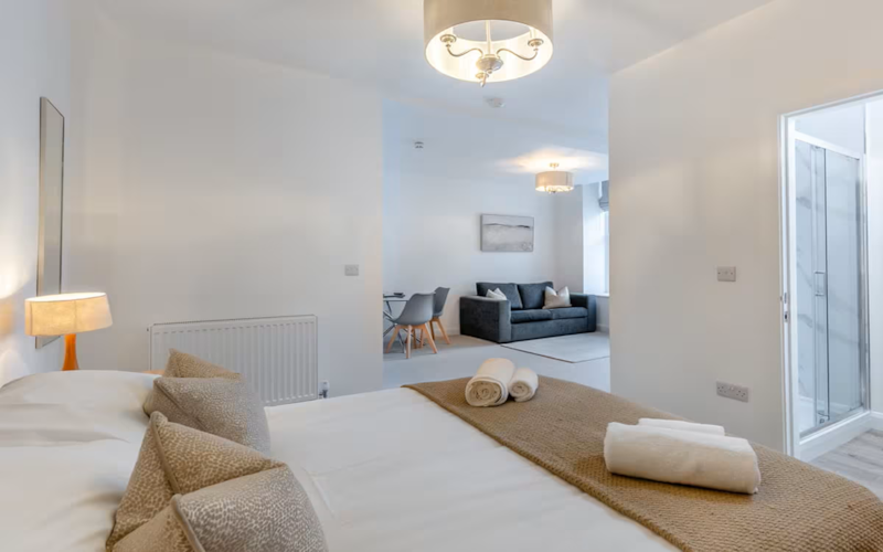 Bedroom with a view through to the lounge area