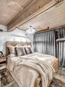 Loft bedroom with Cloud king bed, luxury linens, and automated velvet black-out curtains 