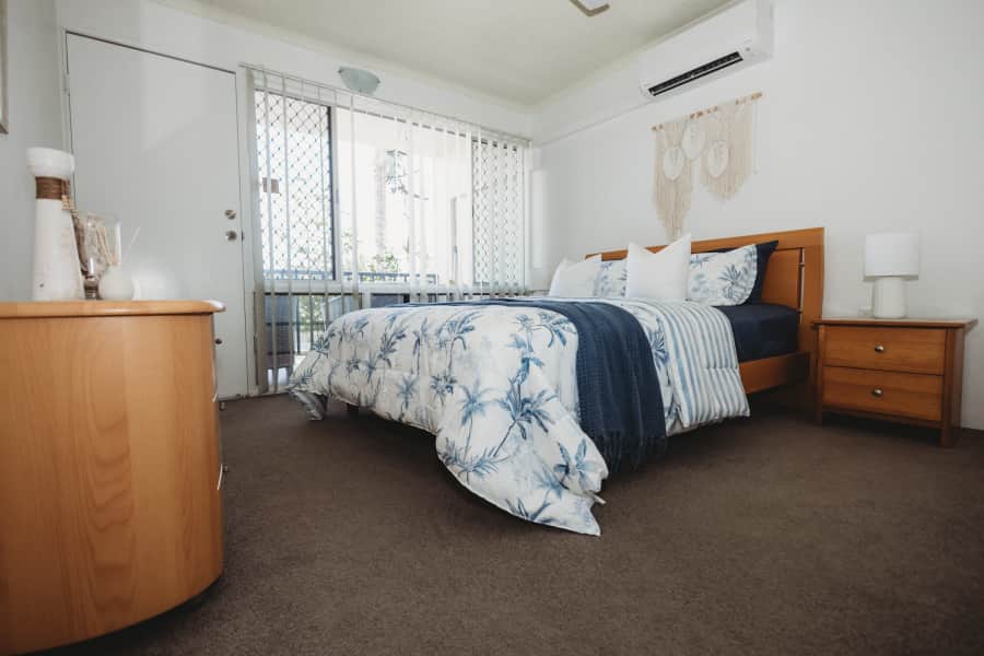The master bedroom features a queen bed, wardrobe and door to the deck. The master bedroom features a queen bed, wardrobe and door to the deck.