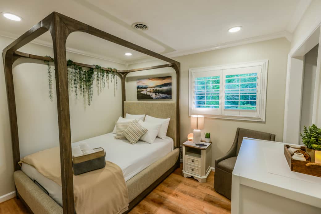 Bedroom with adjustable Queen Bed, 55in TV, shutter blinds, and closet Bedroom with adjustable Queen Bed, 55in TV, shutter blinds, and closet
