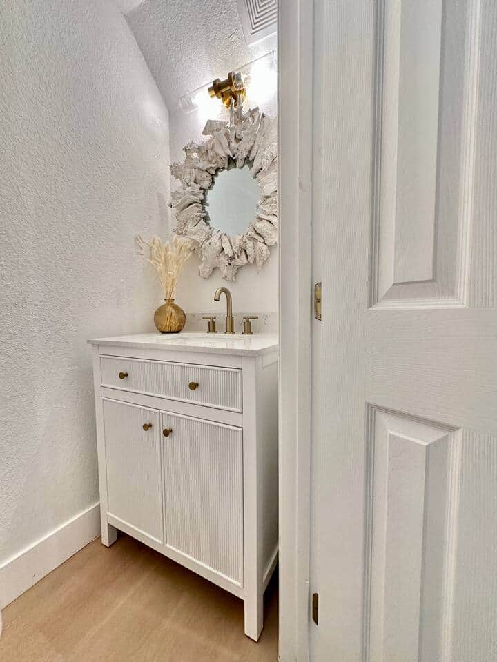 Convenient half bath on the main floor with coastal flair and charming designer touches.
