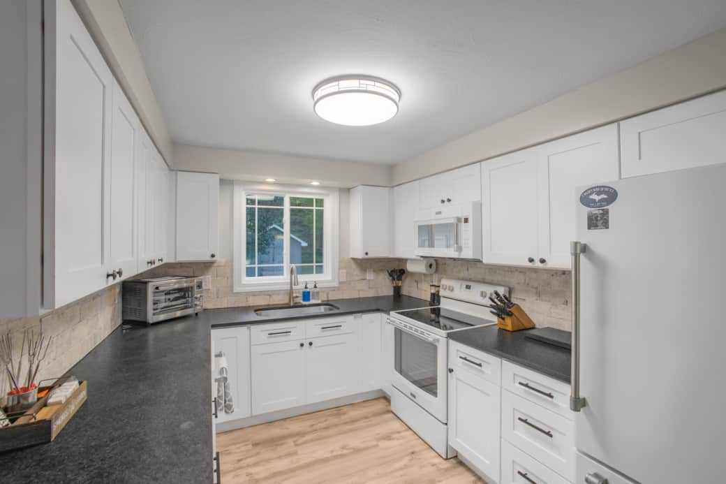 Bright, fully equipped kitchen with plenty of counter space for meals and gathering.