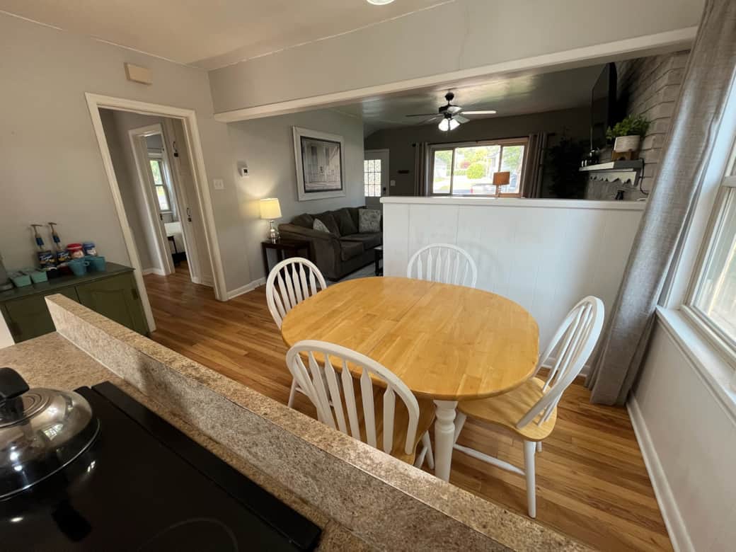 Cozy dining area with seating for four, open to kitchen and living room.