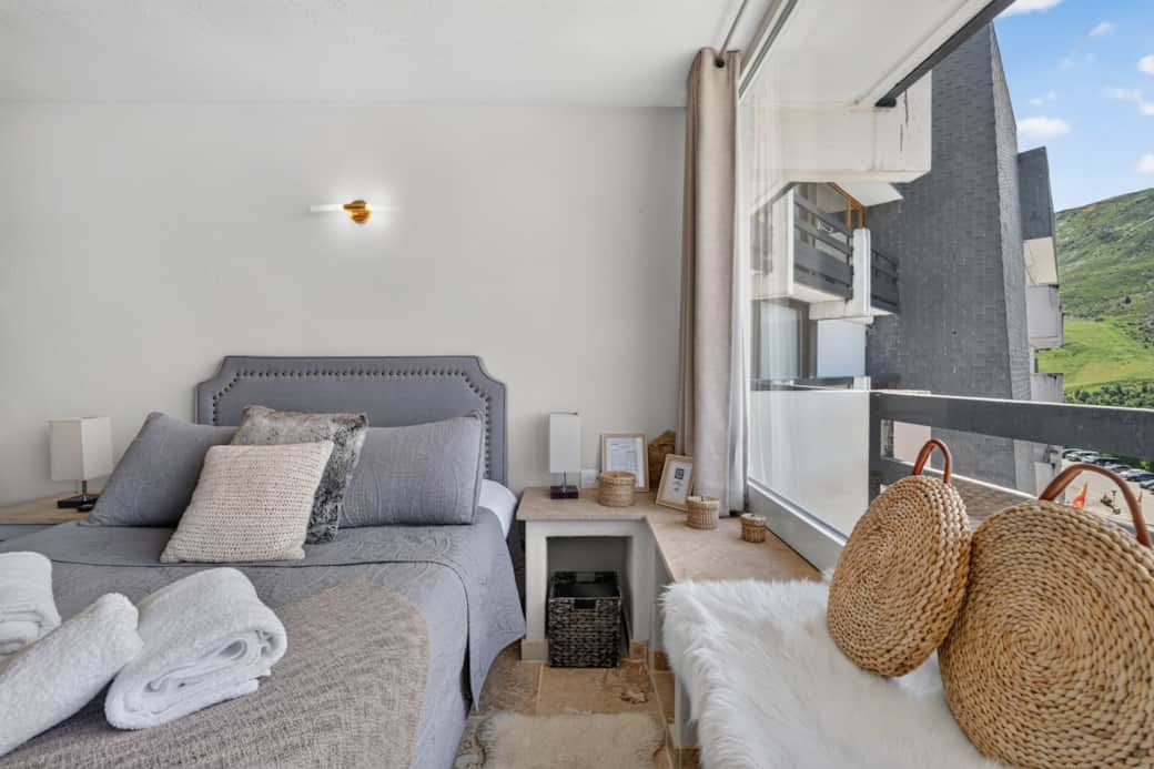 A cozy room with a soft bed and a padded headboard, for perfect rest.