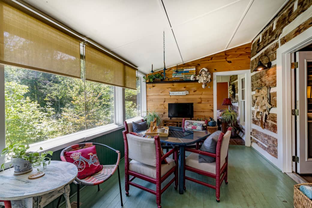 Bright sunroom offers woodland views, comfortable seating, games, and space to unwind