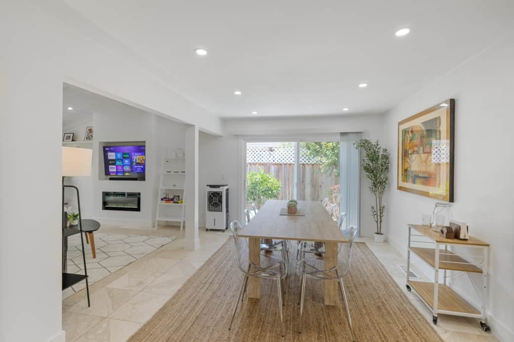 Spacious open-concept dining room featuring a expandable modern dining table set
