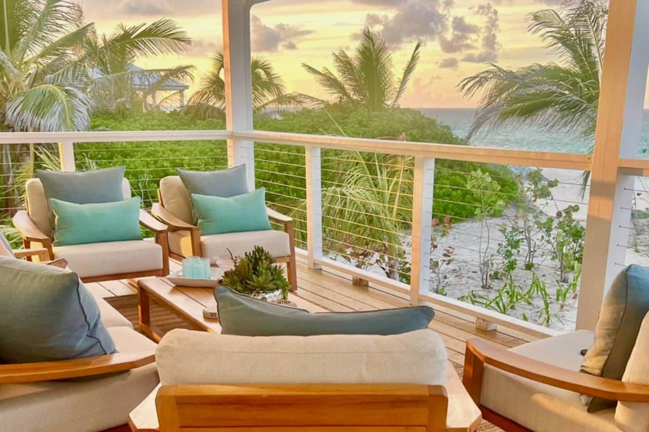 Enjoy morning coffee in the cozy outdoor lounge area with plush teak furniture