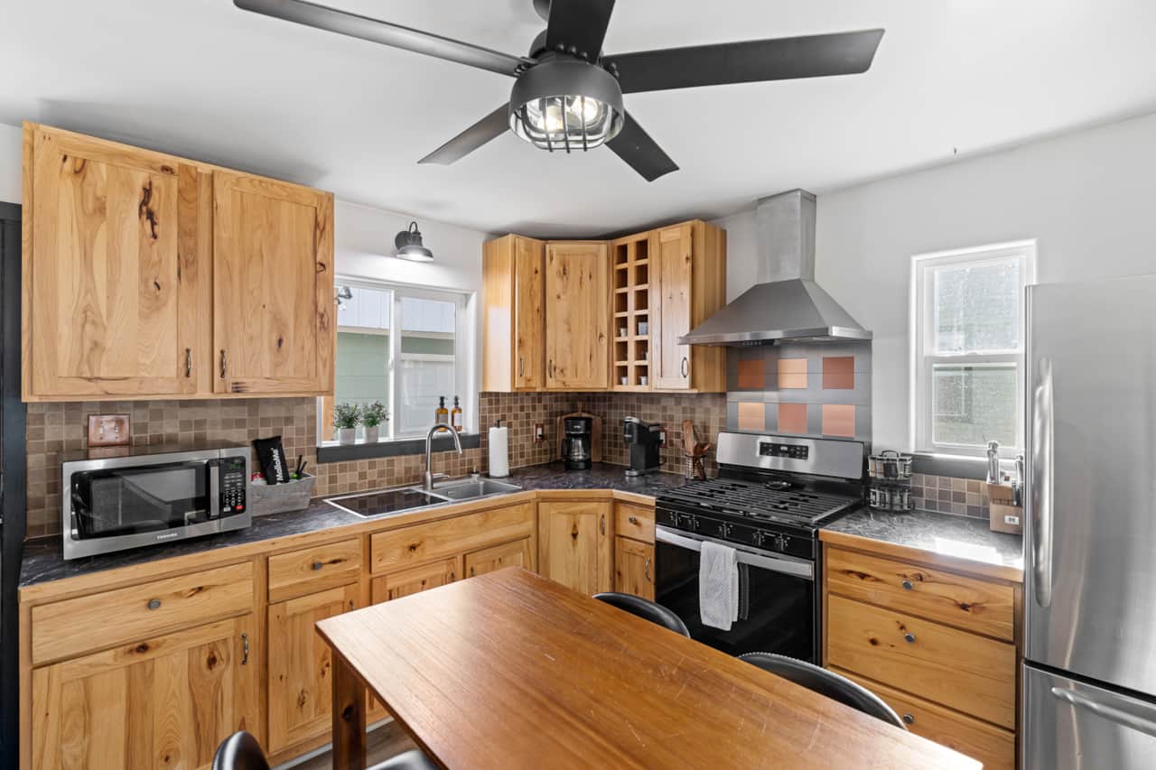 Kitchen: Whip up culinary delights in a stylish space with sleek appliances and natural wood charm!