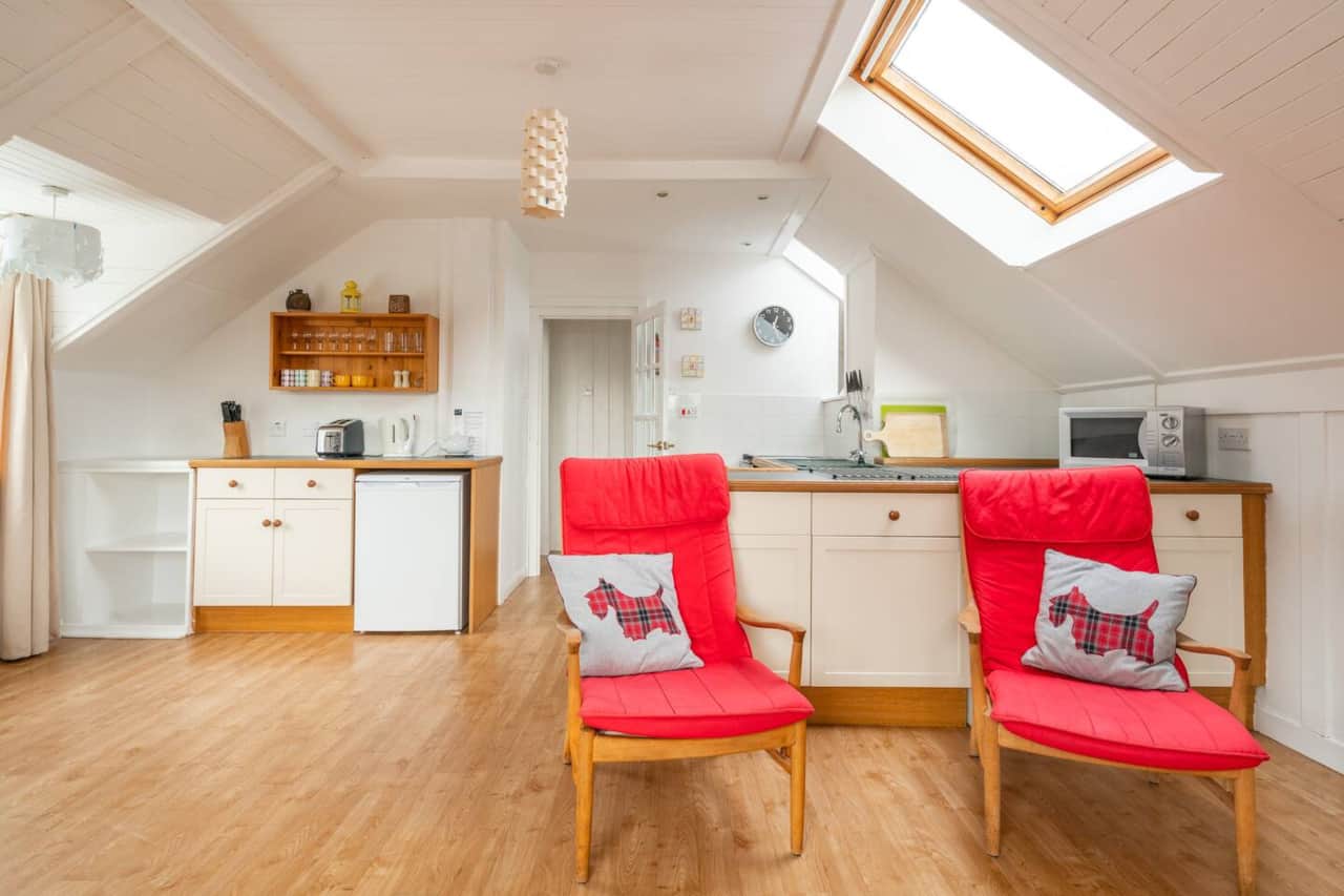 Open-plan living room and kitchen in Castle Cottage