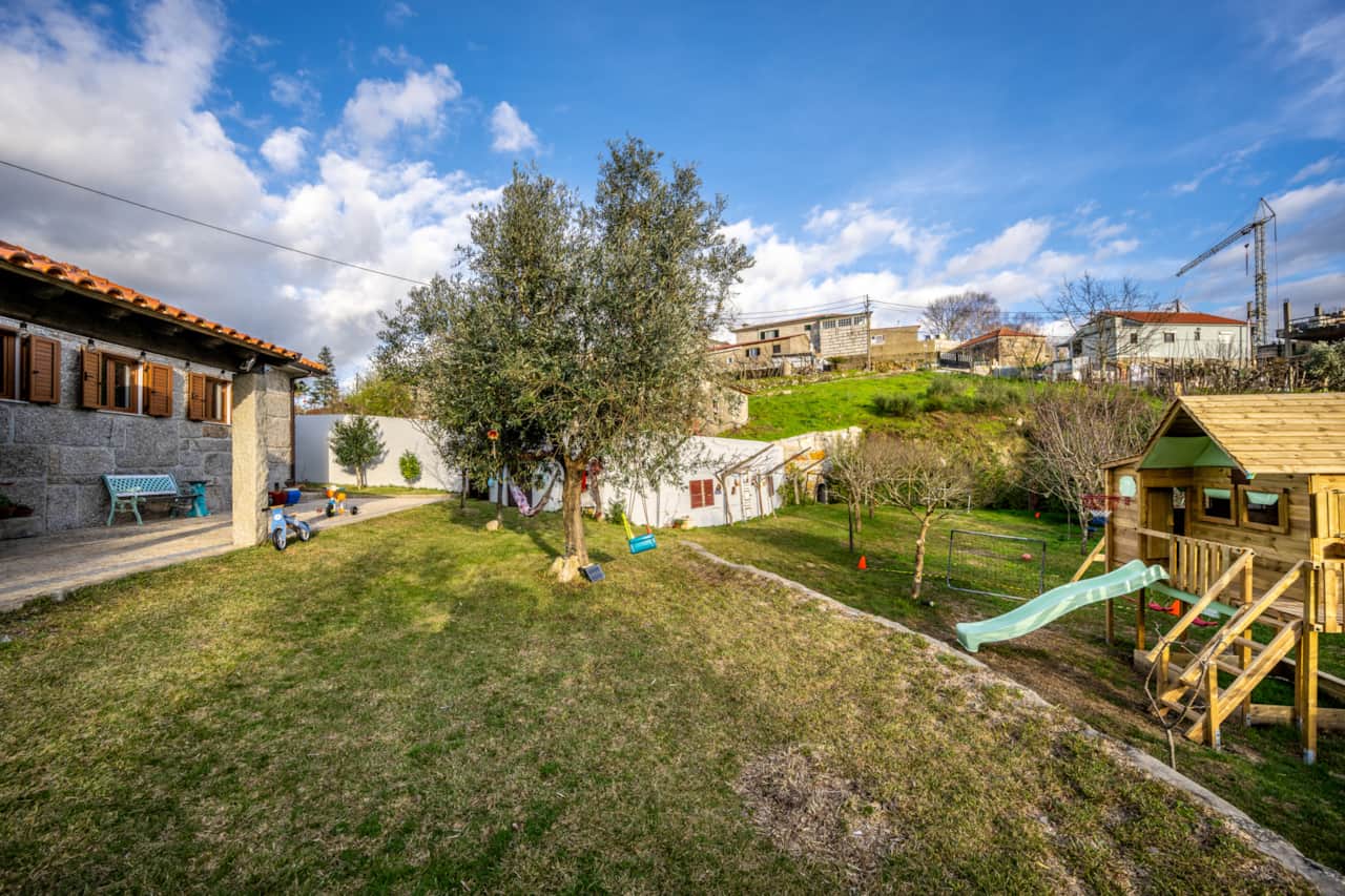 Casa com jardim zona infantil vedada, a casa de madeira e o ambiente seguro.