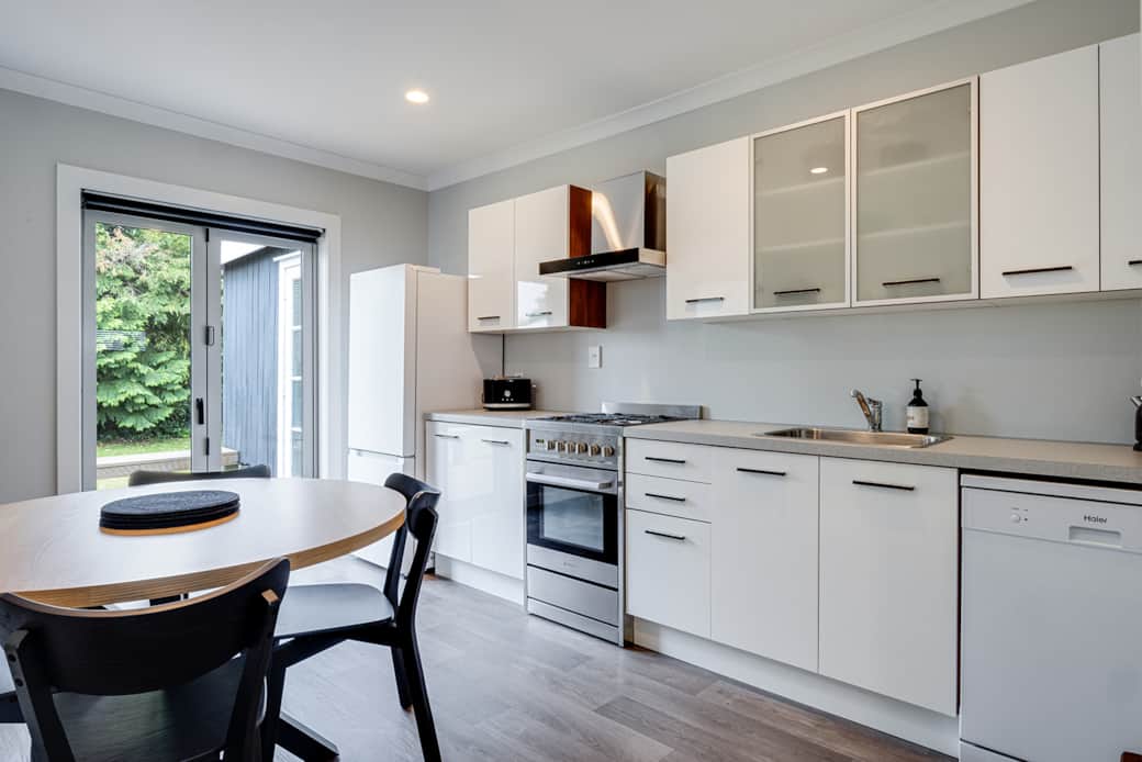 French doors open to the large deck with BBQ and a fully fenced private backyard.