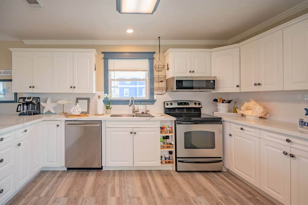 The kitchen is stocked bowls, pans, pots, platters, baking dishes, knives, serving-wear and more