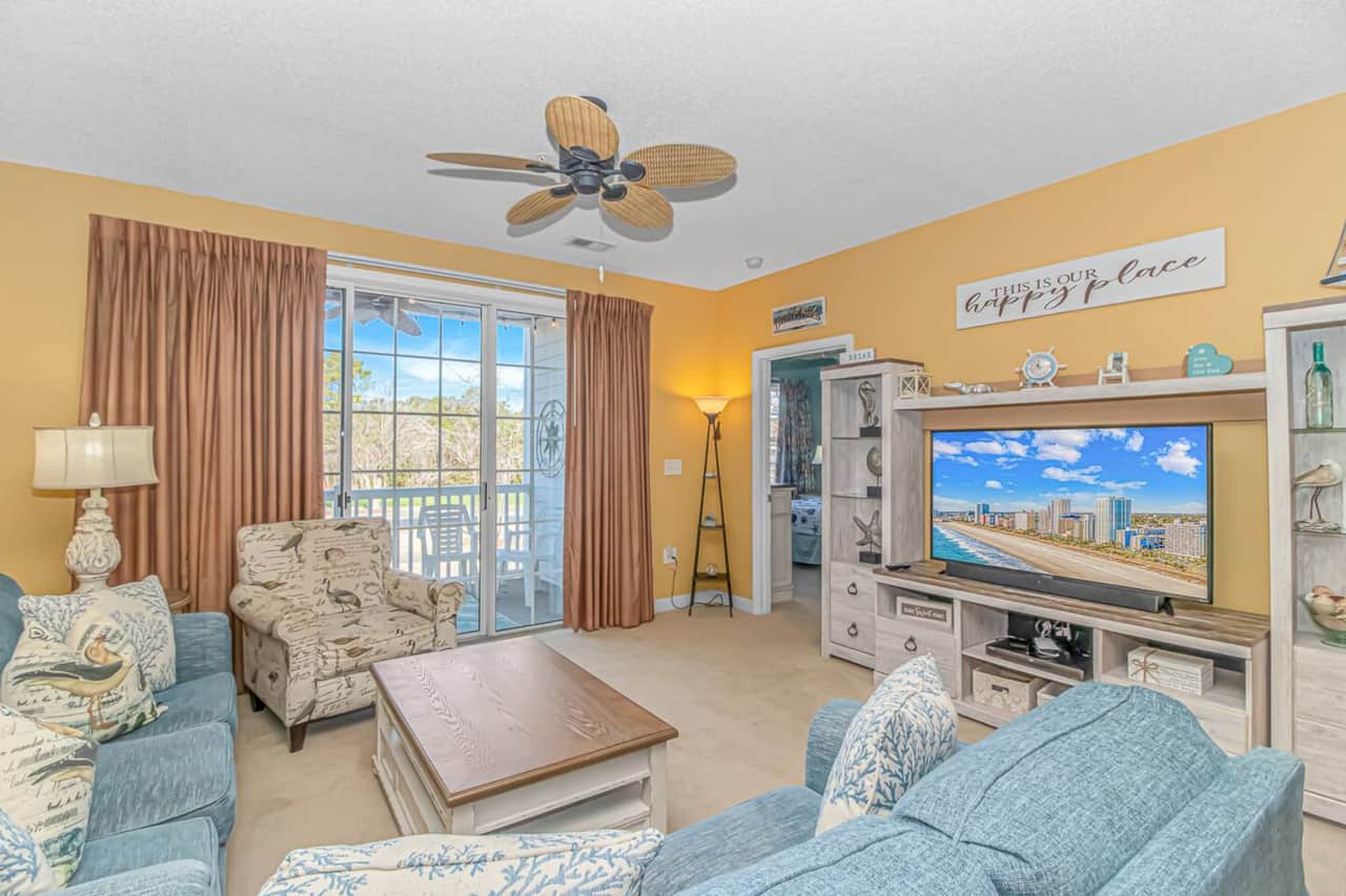Spacious Living Room with Balcony Access
Relax on the cozy sofa and enjoy direct access to the private balcony.

