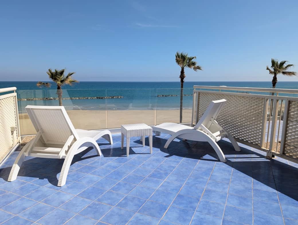 Sun loungers on the private beachfront terrace