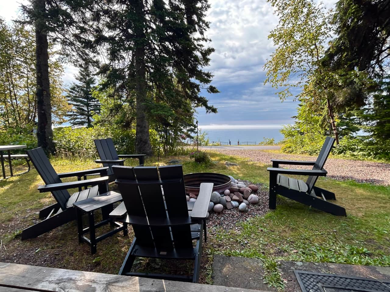 Enjoy your private firepit with gorgeous Lake views. Picnic table to left. Beach access.