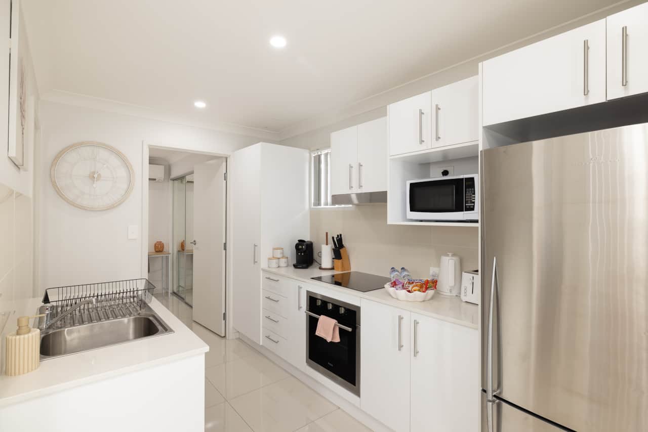 Kitchen: Sleek kitchen with ample storage, modern appliances 
